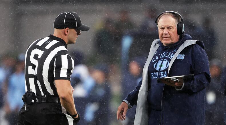 North Carolina head coach Bill Belichick, right, speaks with an official during an NCAA college football game against TCU in Dublin, Ireland, Saturday, Aug. 29, 2026. (AP Photo/Peter Morrison)