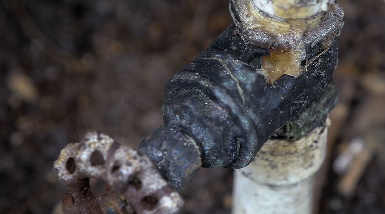 Lupita Del Valle says the management in the Palm Beach Mobile Home Park used tape to repair this pipe beneath her home instead of replacing the damaged parts. Damon Higgins / The Palm Beach Post