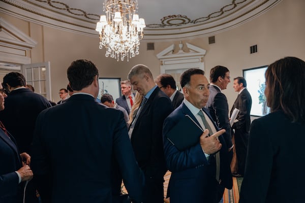 Mark R. George, CEO of Norfolk Southern (center), speaks with attendees during a break at Railway Age’s Next Generation Freight Rail conference at the Union League Club of Chicago on March 10, 2026 in Chicago. (Jamie Kelter Davis for the AJC)