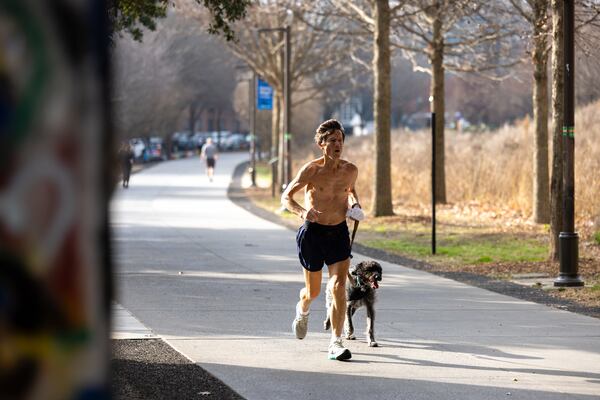 Greg Kibler jogs with his dog on the Beltline in Atlanta on Wednesday, Jan. 7, 2026. (Arvin Temkar/AJC)