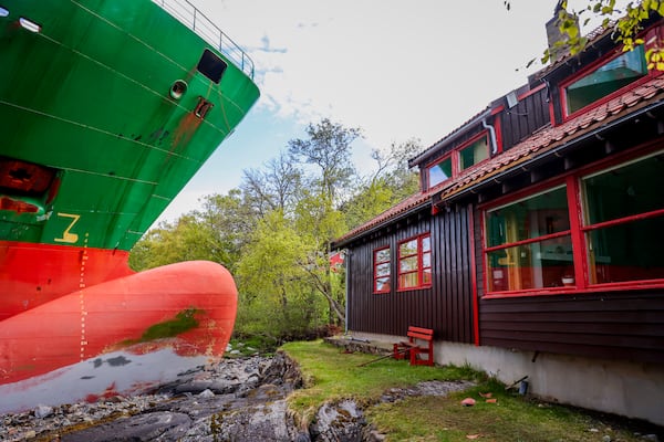 The container ship NCL Salten is seen next to Johan Helberg's house, after the 135-meter-long ship ran aground almost hitting it, in the Trondheimsfjord outside Byneset, in Trondheim, Norway, Thursday May 22, 2025. (Jan Langhaug/NTB Scanpix via AP)