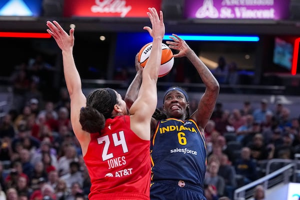 Indiana Fever forward Natasha Howard (6) shoots over Atlanta Dream forward Brionna Jones (24) in the first half of a WNBA basketball game in Indianapolis, Tuesday, May 20, 2025. (AP Photo/Michael Conroy)