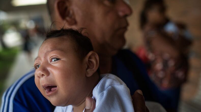 AP SYNDV-ZIKA-012716-AP Joao Batista holds his one-month-old daughter Alice Vitoria in his arms in Recife, Brazil, 21 January 2016. The baby suffers from microcephaly, which manifests in an unusually small head circumference and impaired brain function. The Zika virus transmitted by mosquitos to pregnant women is suspected of causing these issues. Brazil alone is reporting nearly 3900 cases. Photo by: Rafael Fabres/picture-alliance/dpa/AP Images