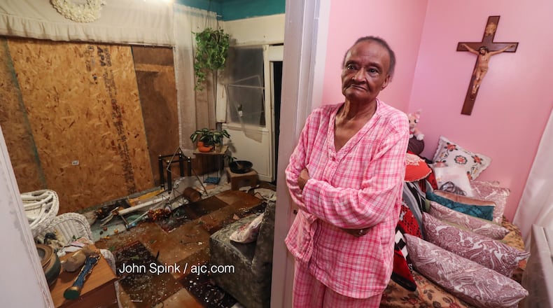 Mary Bledsoe stands in front of what's left of her porch on Burroughs Avenue after a car crashed into it Tuesday night.