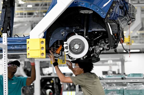 Workers check a Hyundai Ioniq 5 on the assembly line at the South Korean automaker's EV plant on Wednesday, May 6, 2026, in Ellabell, Georgia. (Hyosub Shin/AJC)