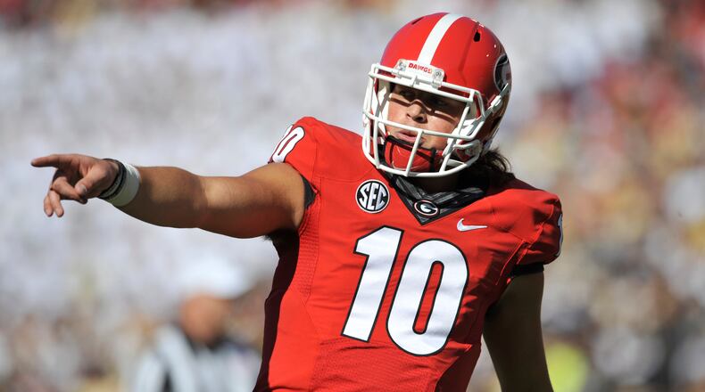 Jacob Eason went down in the first quarter of Saturday’s game against Appalachian State. (DAVID BARNES / AJC)