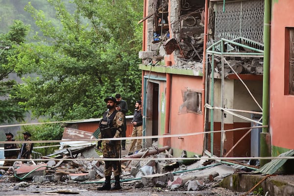 Army soldiers stand guard at a mosque building damaged by a suspected Indian missile attack near Muzaffarabad, the capital of Pakistan controlled Kashmir, on Wednesday, May 7, 2025. (AP Photo/M.D. Mughal)