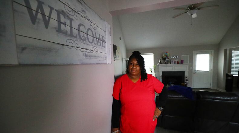 *** VISUAL LEDE *** 020722 SNELLVILLE: Sharanda Hendrickson, a high school nurse, stands in the foyer of her home on Monday, Feb. 7, 2022, in Snellville, discussing how she and her husband had trouble finding housing when their last lease ended in 2020. They are currently renting this home south of Snellville while having to put their dreams of buying a home on hold. Gwinnett leaders face predictions of massive unmet housing demand in Gwinnett County for the next 20 years.  “Curtis Compton / Curtis.Compton@ajc.com”`