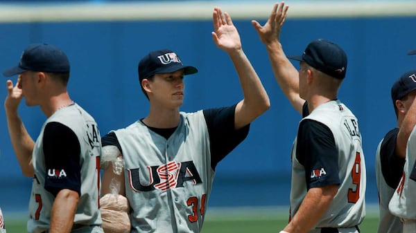 U.S. starting pitcher Kris Benson (34) is is congratulated by teammate Chad Allen after the beating Nicaragua 4-1 in their first game of Olympic baseball Saturday, July 20, 1996 in Atlanta's Fulton County Stadium. Also pictured at left is USA's Mark Kotsay. (Eric Draper/AP)