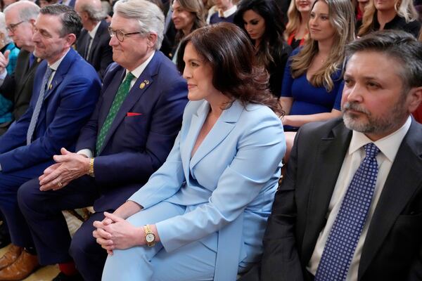 Tina Descovich, co-founder of Moms for Liberty, second from right, listens as President Donald Trump speaks at an education event and executive order signing in the East Room of the White House in Washington, Thursday, March 20, 2025. (AP Photo/Ben Curtis)