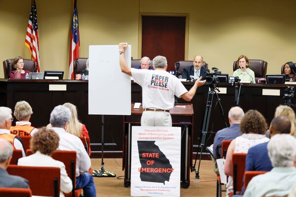 A paper ballot supporter presents his arguments during a State Election Board meeting at Dawson County Government Center on Wednesday, April 25, 2026. (Miguel Martinez/AJC)