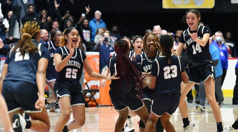 March 12, 2022 Macon - Norcross players celebrate their victory over Harrison during the 2022 GHSA State Basketball Class AAAAAAA Girls Championship game at the Macon Centreplex in Macon on Saturday, March 12, 2022. Norcross won 41-37 over Harrison. (Hyosub Shin / Hyosub.Shin@ajc.com)