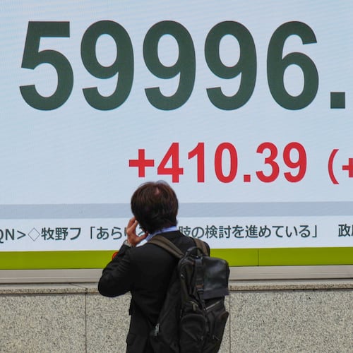 A person looks at an electronic stock board showing Japan's Nikkei index at a securities firm Thursday, April 23, 2026, in Tokyo. (AP Photo/Eugene Hoshiko)