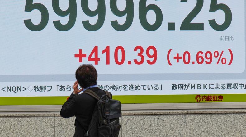 A person looks at an electronic stock board showing Japan's Nikkei index at a securities firm Thursday, April 23, 2026, in Tokyo. (AP Photo/Eugene Hoshiko)