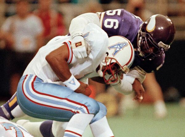 FILE - In this Aug. 27, 1990, file photo, Minnesota Vikings linebacker Chris Doleman (56) brings down Houston Oilers quarterback Warren Moon for a safety during preseason NFL football action in Minneapolis. Hall of Fame defensive end Doleman, who became one of the NFL's most feared pass rushers during 15 seasons in the league, has died. He was 58. The Vikings and Pro Football Hall of Fame president and CEO David Baker offered their condolences in separate statements late Tuesday night, Jan. 29, 2020. (AP Photo/Jim Mone, File)
