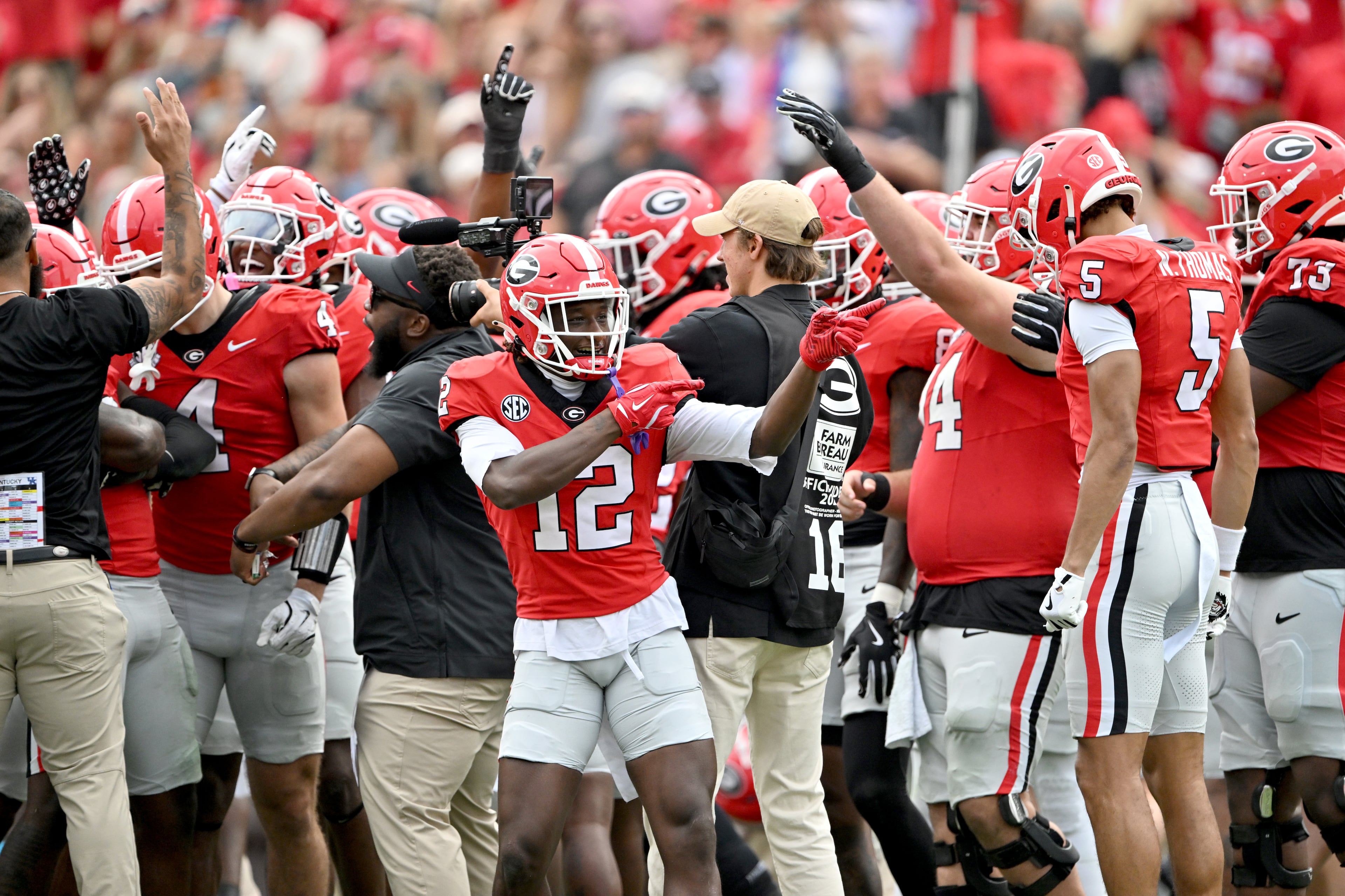 Georgia defensive back Jaden Harris (12) and other players react after recovering a fumble during the second half in a NCAA college football game at Sanford Stadium, Saturday, October 4, 2025, in Athens. Georgia won 35 -14 over Kentucky. (Hyosub Shin / AJC)