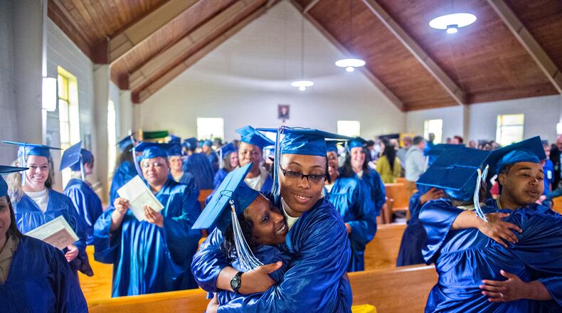 Veronica Fuller (center) hugs Ameshia Ervin (left) after graduating in April 2015 from the theological studies certficate program at the Lee Arrendale Correctional Facility in Alto. U.S. Rep. Doug Collins, R-Gainesville, is leading an effort that would help outgoing federal prisoners re-enter society by serving the final days of their sentences in halfway houses or home confinement if they complete programs such as vocational training, mental health or substance abuse counseling while behind bars. JONATHAN PHILLIPS / SPECIAL
