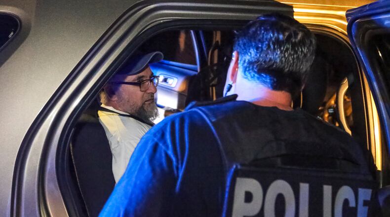 August 18, 2017 Austell: U.S. Immigration and Customs Enforcement officers arrest Jose Serrano (left), a Mexican national with a criminal record, in Austell. JOHN SPINK/JSPINK@AJC.COM