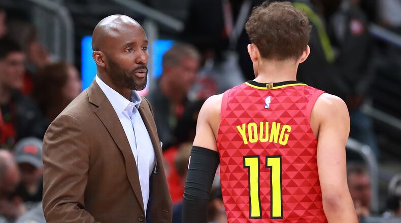 Atlanta Hawks head coach Lloyd Pierce confers with Trae Young against the Milwaukee Bucks in a NBA basketball game on Sunday, March 31, 2019, in Atlanta.    Curtis Compton/ccompton@ajc.com