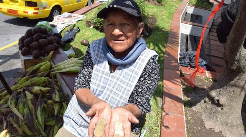 Luzmila Mita holds Sacagawea dollar coins in Quito, Ecuador. Sacagawea, an 18th Century Shoshone tribeswoman, is seen as something of a kindred spirit in Ecuador.  (Jim Wyss/Miami Herald/TNS)