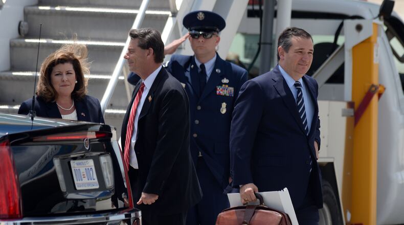 GOP congressional candidate Karen Handel walks towards the presidential limo as U.S. Sen.Ted Cruz, heads for another vehicle in the motorcade as President Donald Trump arrives at Hartsfield Jackson International Airport aboard Air Force One on Friday. Kent D. Johnson, kdjohnson@ajc.com