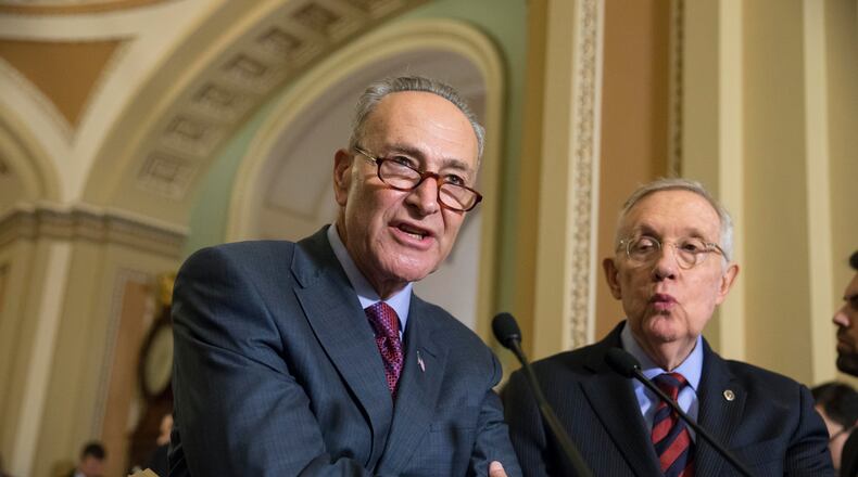 Sen. Chuck Schumer, D-N.Y., joined by Senate Minority Leader Harry Reid, D-Nev., right, criticizes Republicans for not doing enough to stop gun violence, during a news conference on Capitol Hill in Washington. On Sunday, Dec. 13, 2015, Schumer joined Gov. Andrew Cuomo in calling on federal officials to set up a protocol to allow states access to the normally confidential FBI terrorism watch list. (AP Photo/J. Scott Applewhite, File)