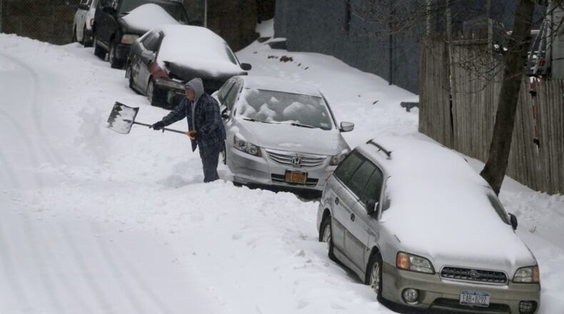 AP Photo/Julie Jacobson A man digs his car out along William Street during a snow storm, Tuesday, March 14, 2017, in New York. New York Gov. Andrew Cuomo has declared a state of emergency Tuesday for all of New York's 62 counties, including New York City's five boroughs.