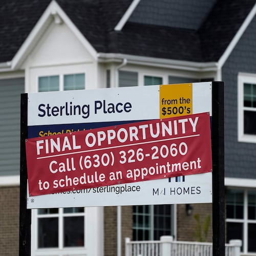 FILE - An advertising sign for building land stands in front of a new home construction site in Northbrook, Ill., on May 5, 2022. (AP Photo/Nam Y. Huh, File)