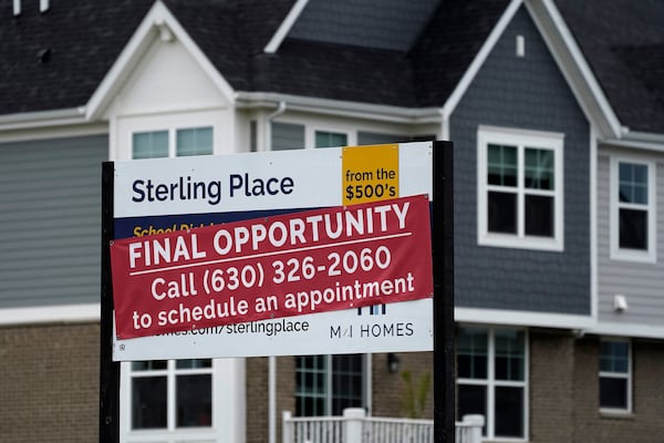 An advertising sign for building land stands in front of a new home construction site in Northbrook, Ill., in 2022. (Nam Y. Huh/AP)