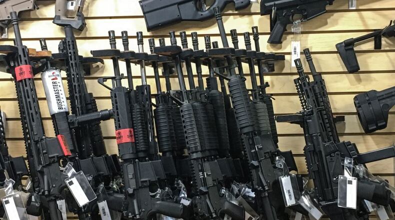 Guns stacked in a store.