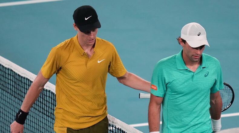Jannik Sinner, left, of Italy walks from the court with Eliot Spizzirri of the U.S. after winning their third round match at the Australian Open tennis championship in Melbourne, Australia, Saturday, Jan. 24, 2026. (AP Photo/Dar Yasin)