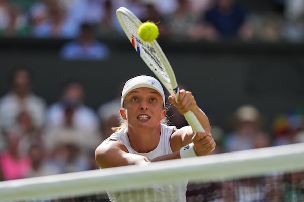 Poland's Iga Swiatek returns to Amanda Anisimova of the U.S. during the women's singles final at the Wimbledon Tennis Championships in London, Saturday, July 12, 2025. (AP Photo/Kin Cheung)