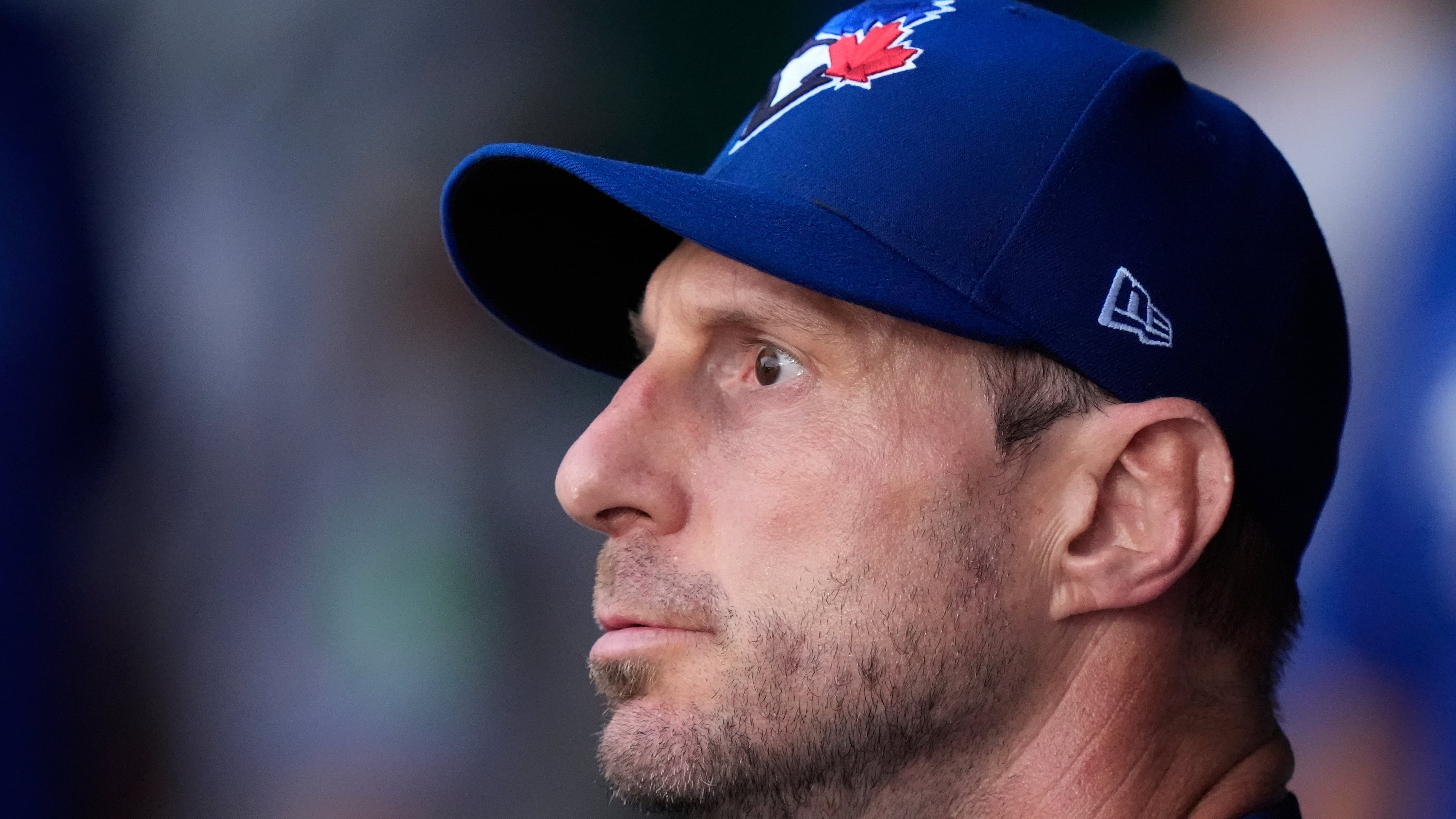 Toronto Blue Jays starting pitcher Max Scherzer watches from the dugout after coming out of the game during the first inning of a baseball game against the Kansas City Royals, Friday, Sept. 19, 2025, in Kansas City, Mo. (AP Photo/Charlie Riedel)