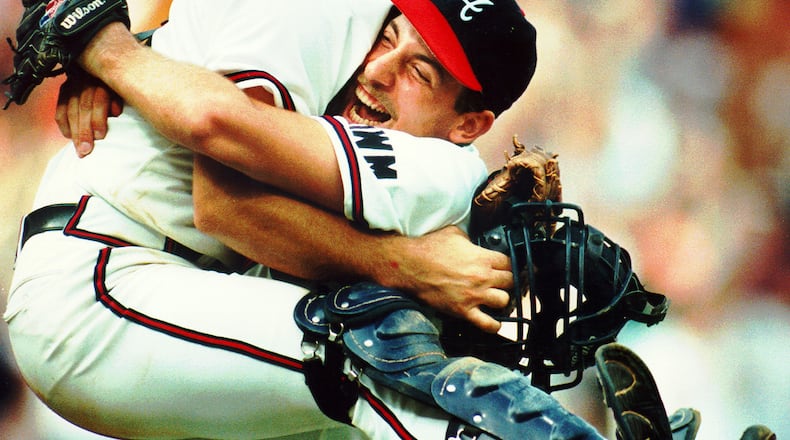 Atlanta Braves' catcher Greg Olson jumps into the arms of winning pitcher John Smoltz after the Braves 5-2 victory Oct. 5, 1991, over the Astros and clinched at least a tie for the National League West title. San Francisco later beat the Los Angeles Dodgers to give the Braves sole possession of the NL West.
