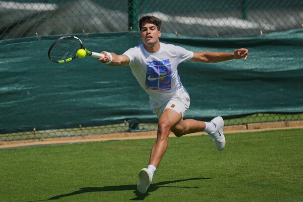 Carlos Alcaraz of Spain plays a return during a practice session ahead of the Wimbledon Championships in London, Friday, June 27, 2025. (AP Photo/Kin Cheung)