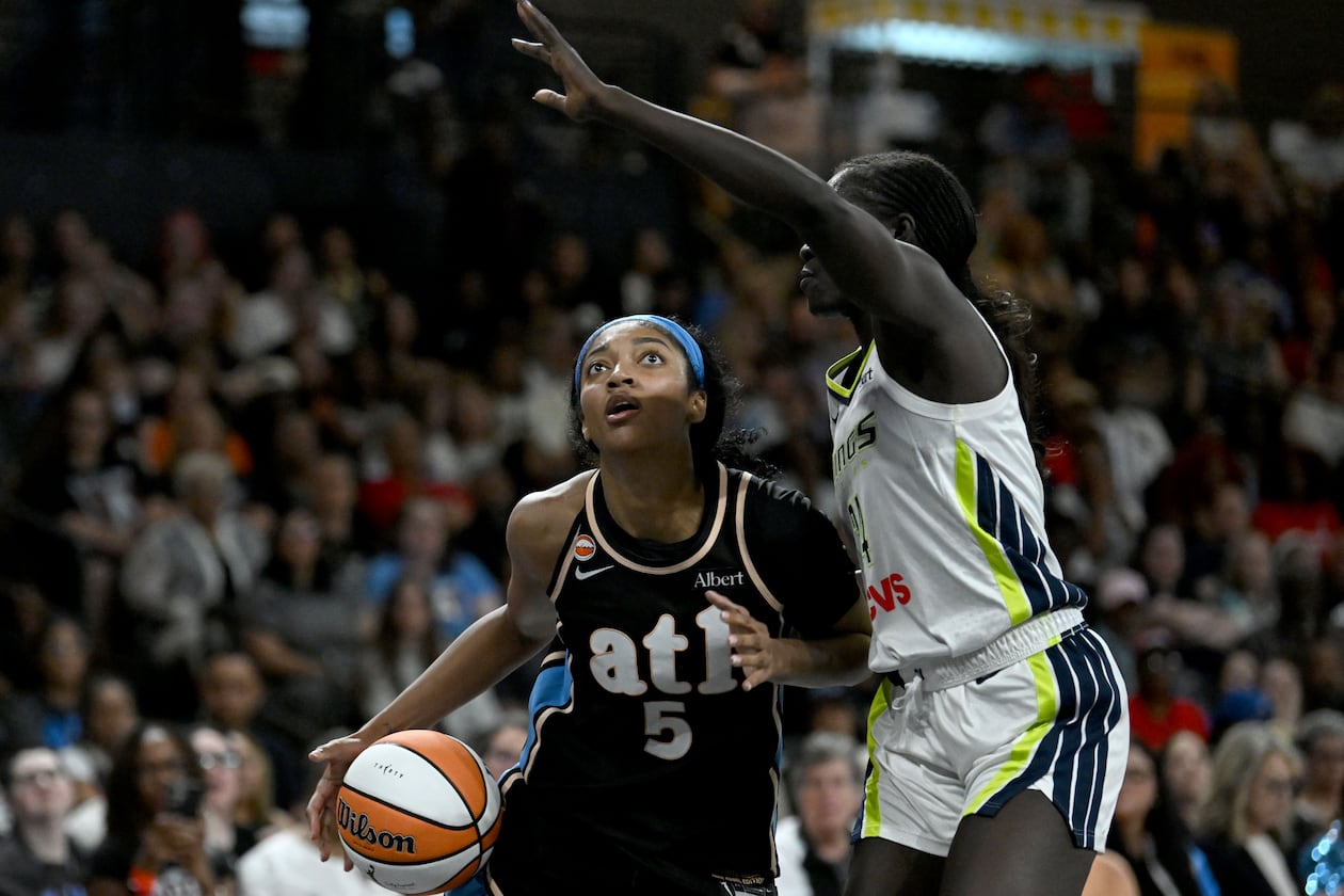 Atlanta Dream forward Angel Reese (5) drives against Dallas Wings forward Awak Kuier (34) during the second half of a WNBA game at Gateway Center Arena on Friday, May 22, 2026, in Atlanta. Atlanta Dream won 86-69 over Dallas Wings. (Hyosub Shin/AJC)