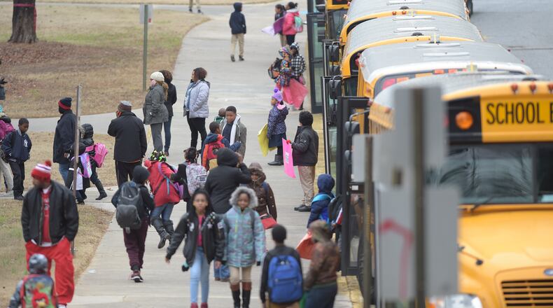 Students head to waiting buses as they dismiss early from Woodridge Elementary School on Friday Jan. 6, 2017. KENT D. JOHNSON/ KDJOHNSON@AJC.COM