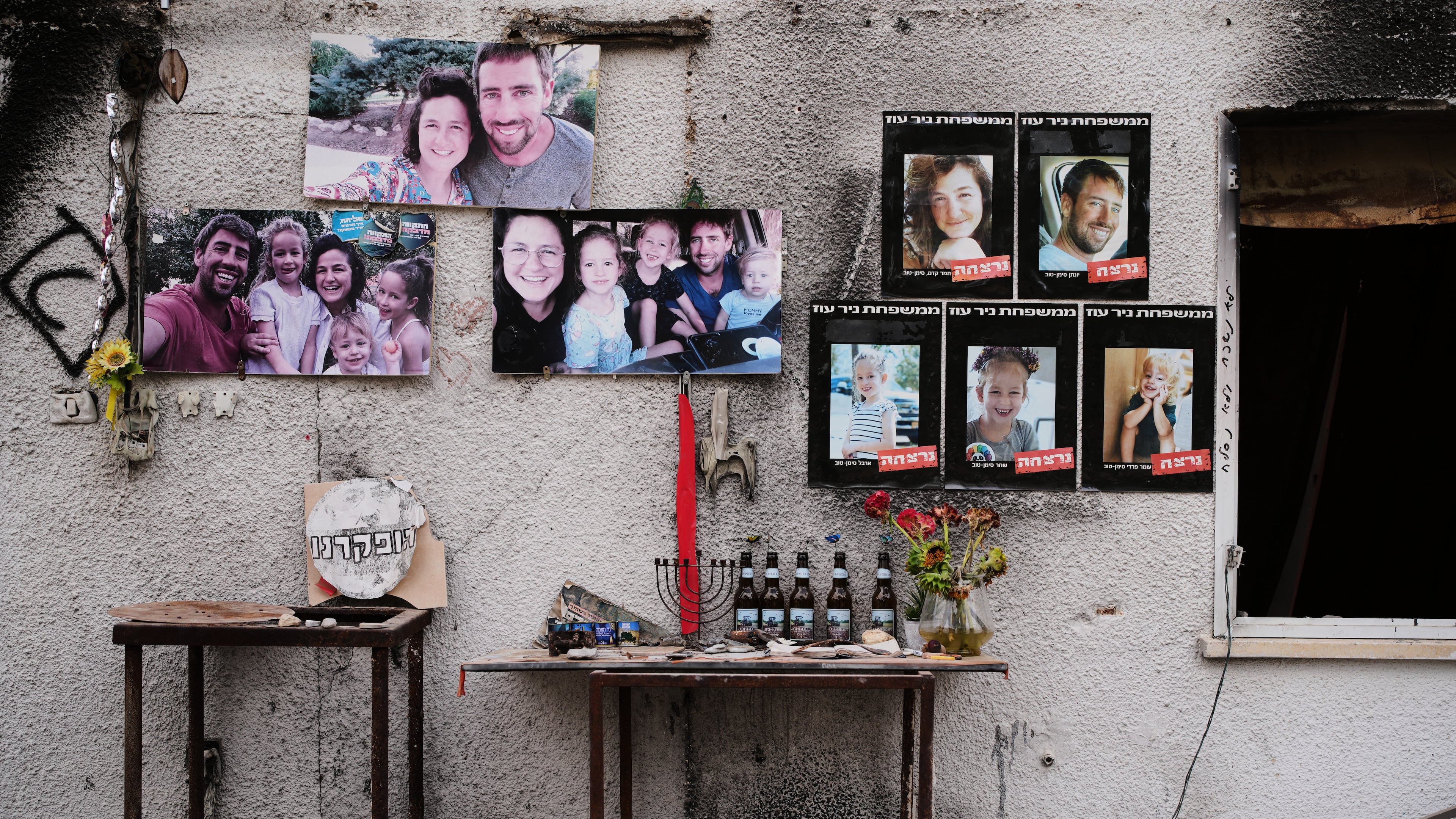 Photos of the Siman Tov family are plastered on their burnt house where all five of them were killed during the Hamas attack on Oct. 7, 2023, in Kibbutz Nir Oz, Israel, a day before Israel marks the two-year anniversary of the attack, Monday, Oct. 6, 2025. (AP Photo/Ohad Zwigenberg)