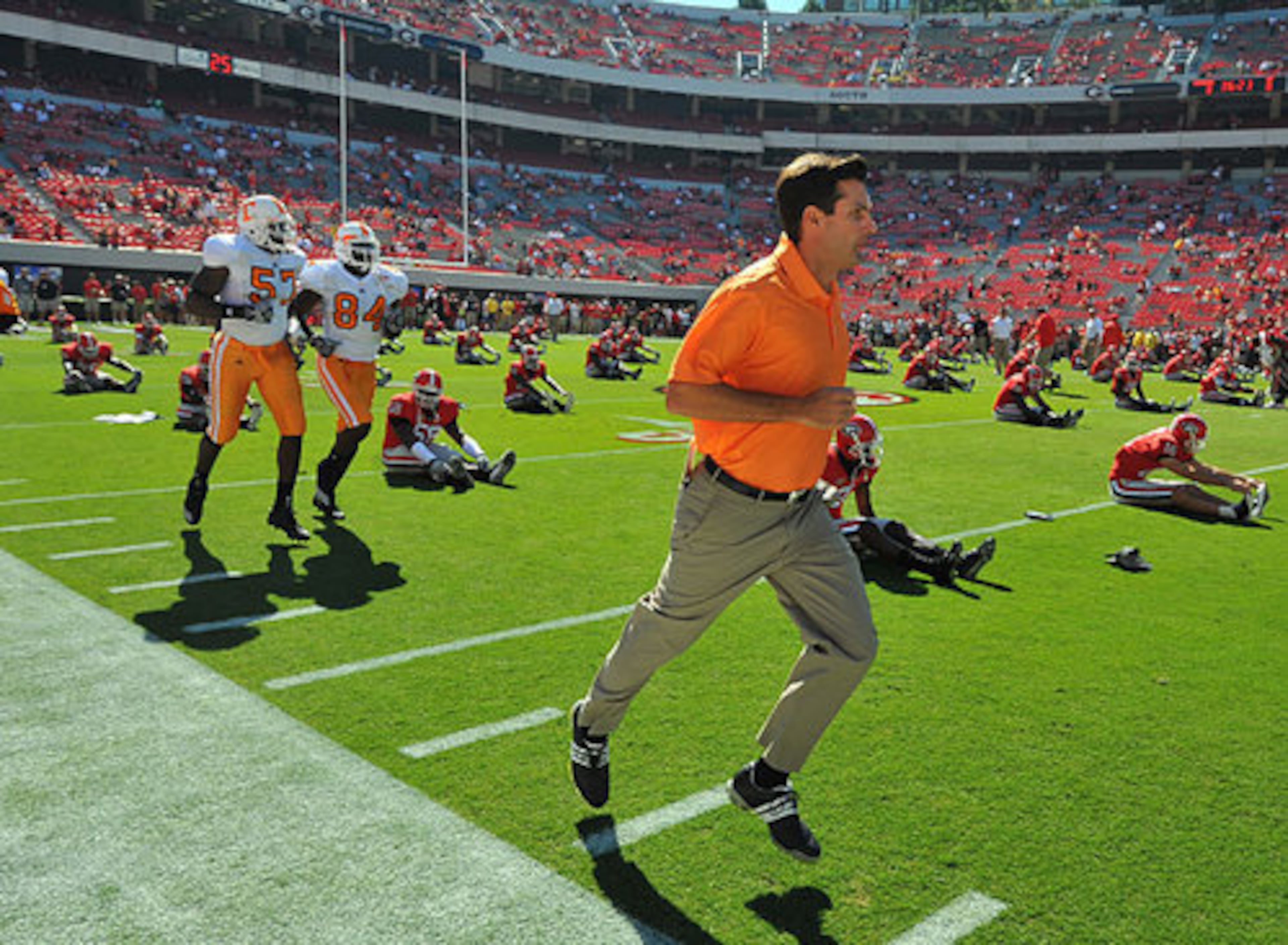 Then-Tennessee head coach Derek Dooley, son of UGA coaching legend Vince Dooley, jogs onto the field for pre-game warm-up in 2010. (Brant Sanderlin/AJC)