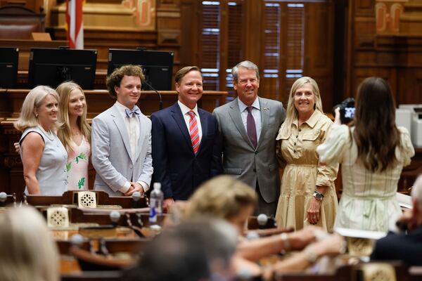 Gov. Brian Kemp and first lady Marty Kemp (far right) pose for a photo with Georgia Court of Appeals Judge Brian Epps, his wife Amy, and their children, Jack and Eliza, at the House Chambers in the State Capitol on Tuesday, Aug. 11, 2026. (Miguel Martinez/AJC)