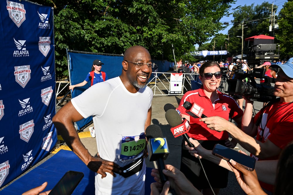 U.S. Sen. Raphael Warnock, D-Ga., spoke to the news media after crossing the finish line of the AJCs Peachtree Road Race in Atlanta on Friday.