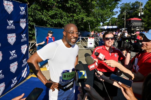 U.S. Sen. Raphael Warnock, D-Ga., spoke to the news media after crossing the finish line of the AJC’s Peachtree Road Race in Atlanta on Friday.