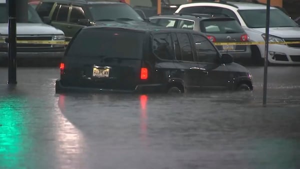This image made from video shows cars submerged in floodwaters in Rahway, NJ., on July 14, 2025.(WABC-TV via AP)