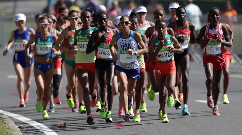 Athletes compete in the women's marathon during the Summer Olympics athletics event in Rio de Janeiro, Brazil, Sunday, Aug. 14, 2016. At front center is Desiree Linden, of the United States. (AP Photo/Robert F. Bukaty)