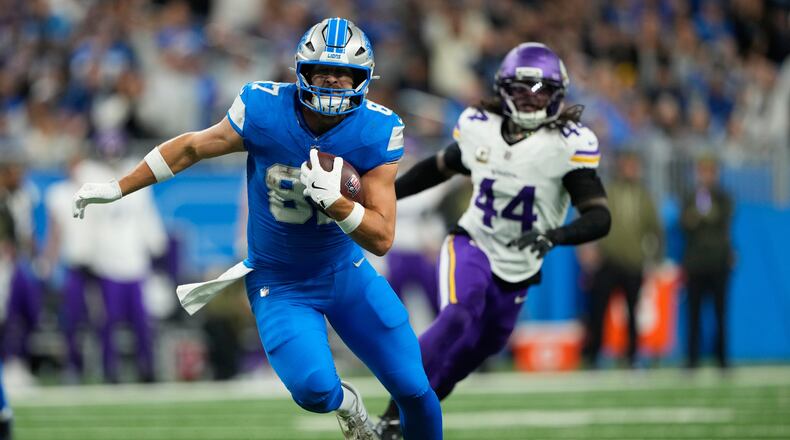 Detroit Lions tight end Sam Laporta (87) runs to score a touchdown during the first half of an NFL football game against the Minnesota Vikings Sunday, Nov. 2, 2025, in Detroit. (AP Photo/Ryan Sun)
