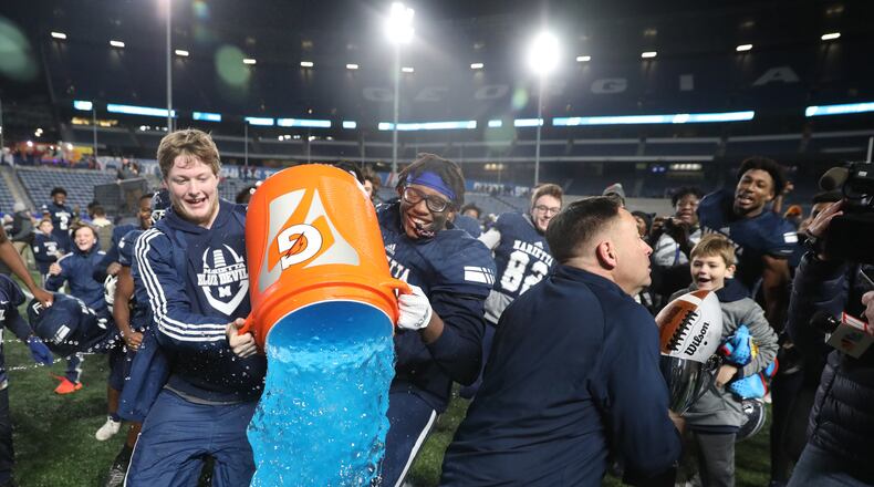 December 14, 2019 - Atlanta, Ga: Marietta head coach Richard Morgan dodges the gatorade dump by players after Marietta's 17-9 win against Lowndes in the Class AAAAAAA high school football state title at Georgia State Stadium Saturday, December 14, 2019 in Atlanta. (JASON GETZ/SPECIAL TO THE AJC)