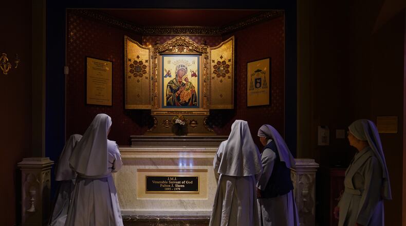 Nuns pray at the tomb of Archbishop Fulton Sheen at the Cathedral of St. Mary of the Immaculate Conception in Peoria, Ill., on July 15, 2026. (AP Photo/Jessie Wardarski)
