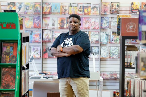 Tony Cade, owner of Challenges Games and Comics, poses for a photograph at his new shop location in Tucker on Wednesday, August 19, 2026. After being forced to leave Northlake Mall, he found a new home in Tucker, where customers began showing support. (Miguel Martinez/AJC)