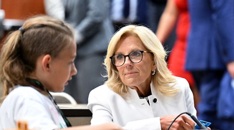First Lady Jill Biden experiences soldering as one of students helps as she and other officials visit Cougar Manufacturing Camp, where students age 12-14 learn about virtual reality and STEM activities, during America Workforce Hub tour at Augusta Technical College, Tuesday, July 18, 2023, in Augusta, Georgia. First Lady Jill Biden and U.S. Secretary of Education Miguel Cardona meet with local officials and key stakeholders leading the Investing in America Workforce Hub in Augusta, Georgia to highlight to how Bidenomics is delivering investments and jobs to communities across the country. (Hyosub Shin / Hyosub.Shin@ajc.com)
