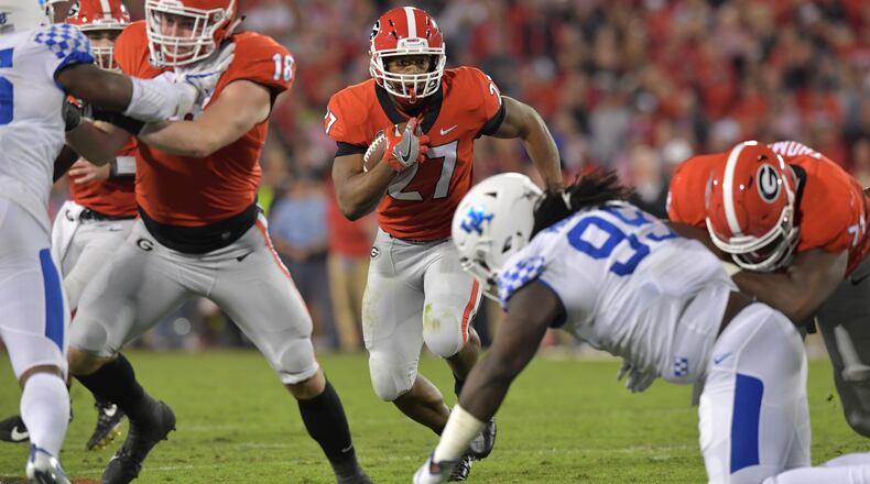 Georgia running back Nick Chubb (27) runs for a first down in the first half Saturday, Nov. 18, 2017, in their 42-13 win over Kentucky.